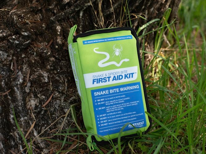 FastAid Snake and Spider Bite Green Soft Pack First Aid Kit on the grass