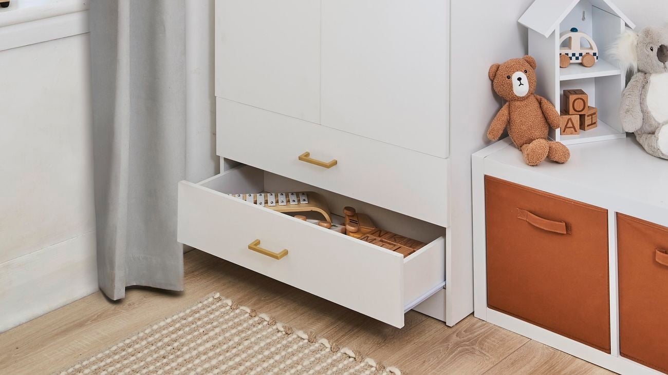 White wardrobe and cube storage unit in an earthy-toned kids room