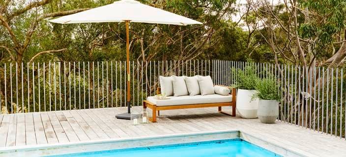 outdoor setting along with a pool and shade umbrella