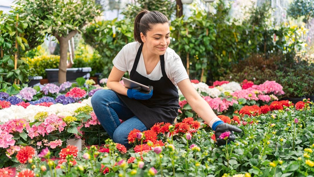 woman in a flower garden looking and smiling