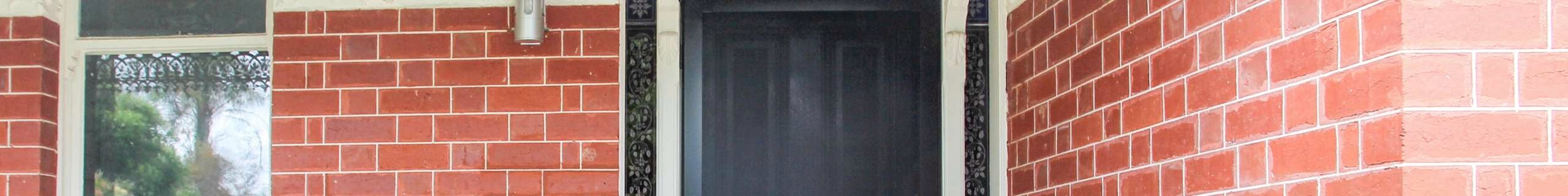 Security door at the front of a red brick house