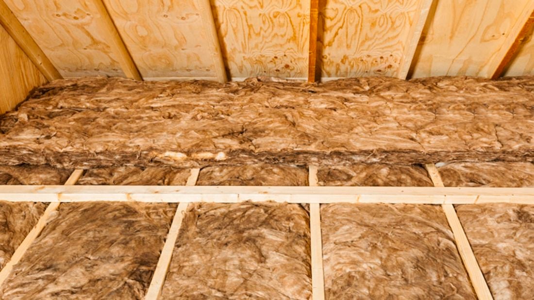 Insulation fitted into a roof cavity.