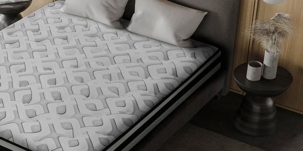 Giselle Bedding mattress with geometric pattern in a modern bedroom.