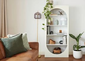 Bookcase styled with home decor objects.