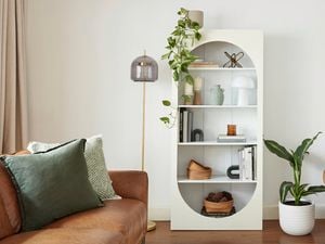 Bookcase styled with home decor objects.