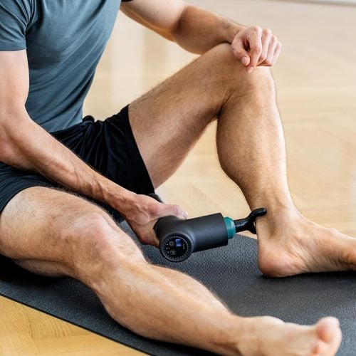 A man using a heat product to help with his ankle