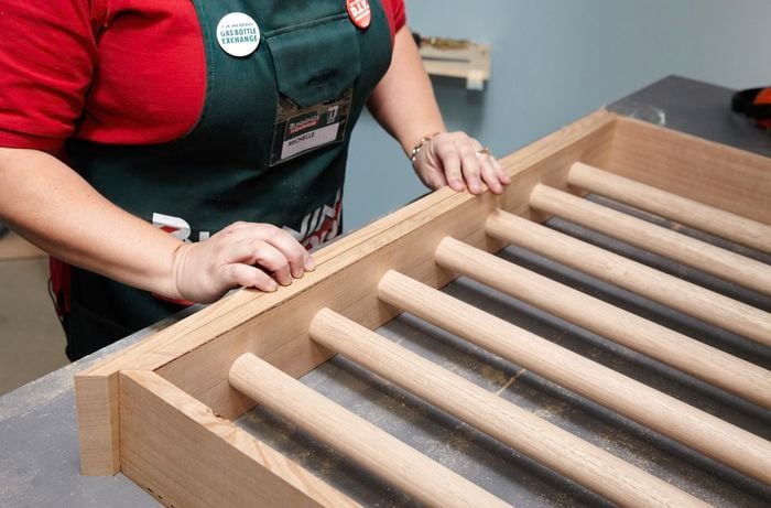 Person measuring and marking timber frame