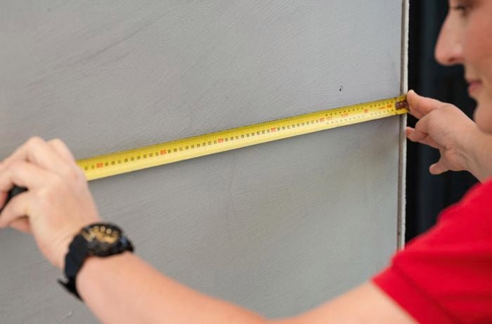 A bunnings team member with a tape measure.
