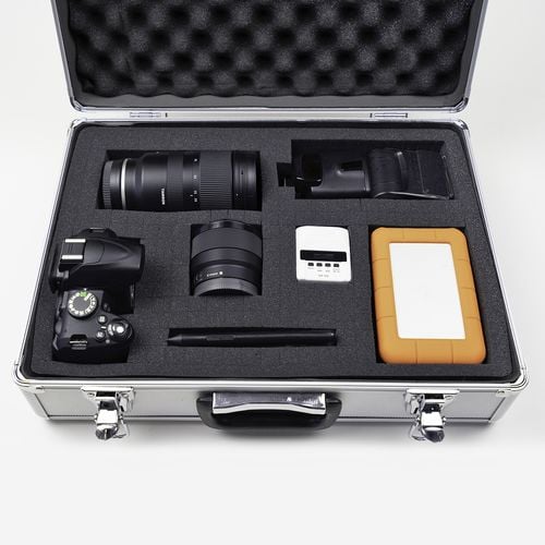 Case containing camera and accessories in fitted foam base