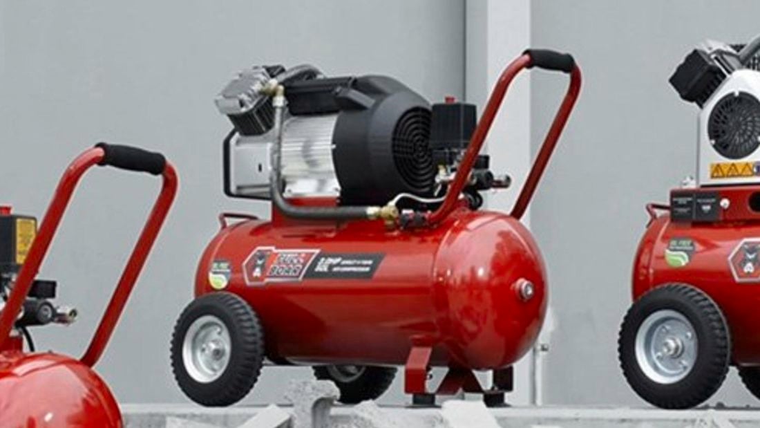 Three red modern air compressors.