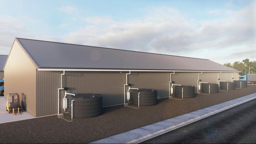 A long shed with round water tanks attached per section by downpipe.
