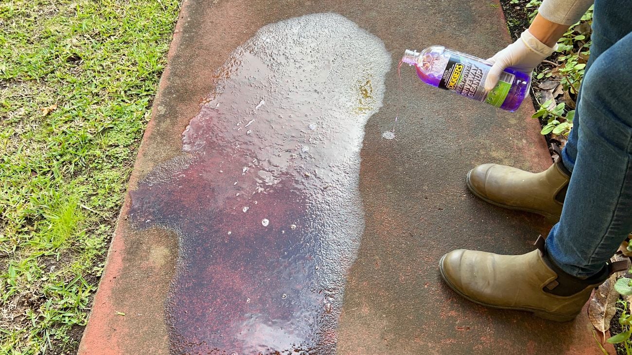 Driveway Cleanup bottle being applied to concrete.