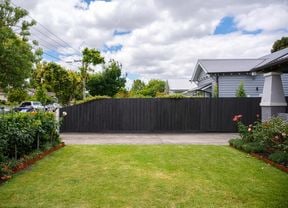 A beautiful garden with a freshly painted fence.