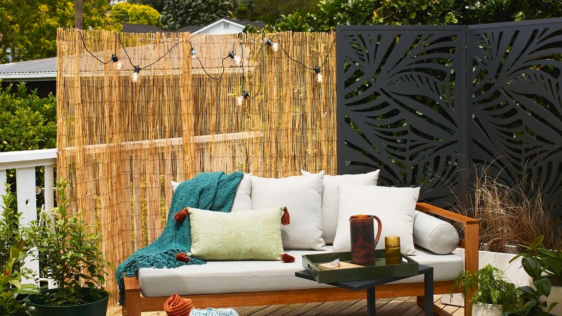 Fenced backyard with lawn, plants and outdoor barbeque