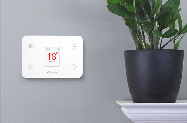 Digital thermostat attached to wall