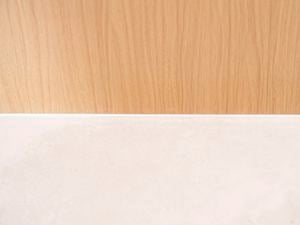 Smooth finished silicone sealant applied along the gap between timber and benchtop.