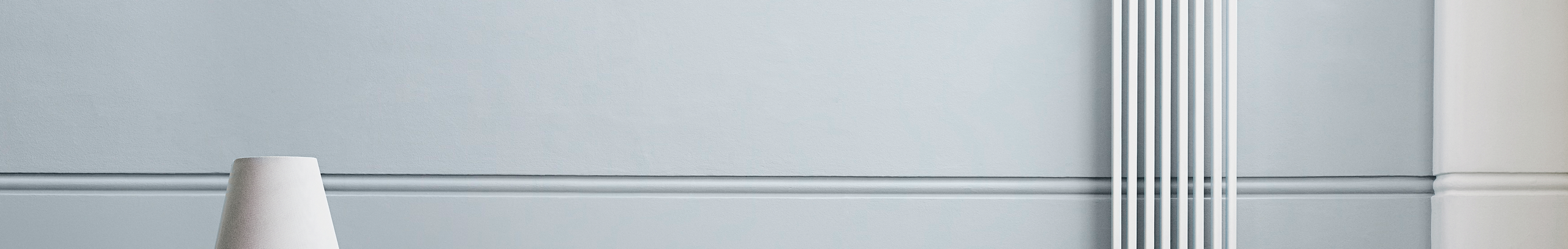 Wall painted blue with light switch that is cork coloured 