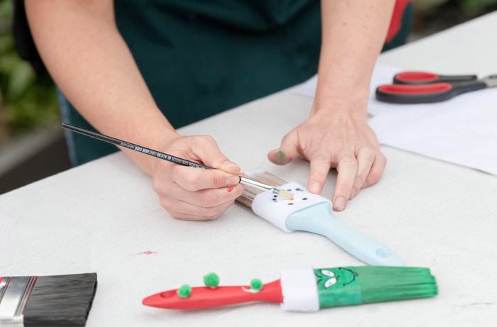 Adding further embellishments to your paint brush decoration