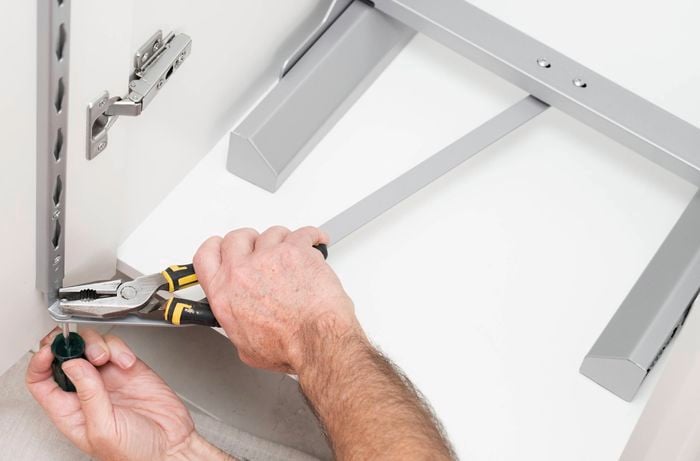 Reattach the door and fix the connecting strips