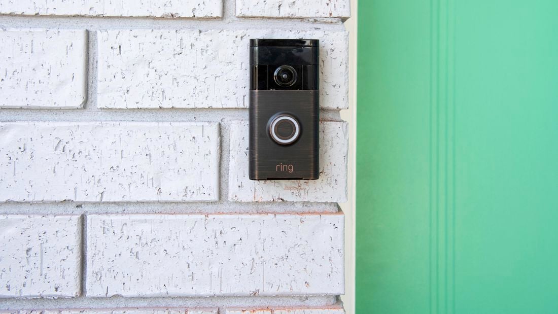 Ring doorbell on brick wall next to front door.