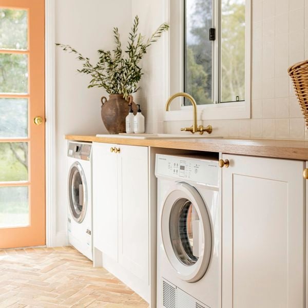 Modern styled laundry with wooden bench tops