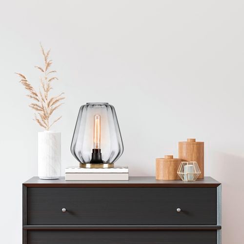 Verve-Design glass lamp on black side table on top of books