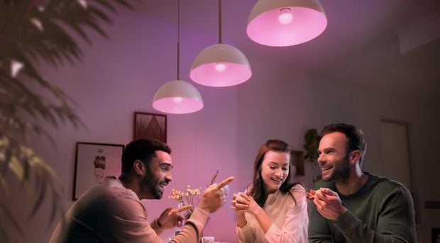 People enjoying each other's company while eating bread rolls