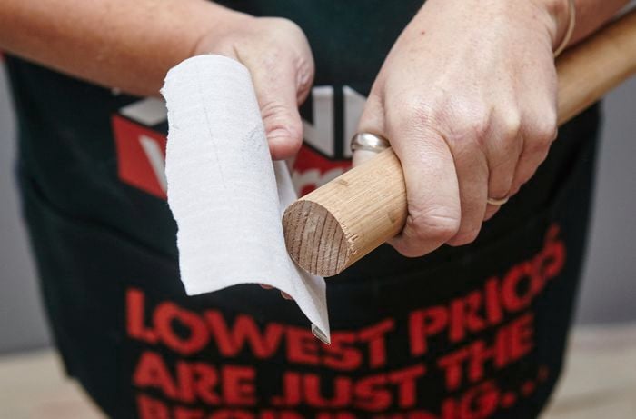 Person sanding timber dowel.