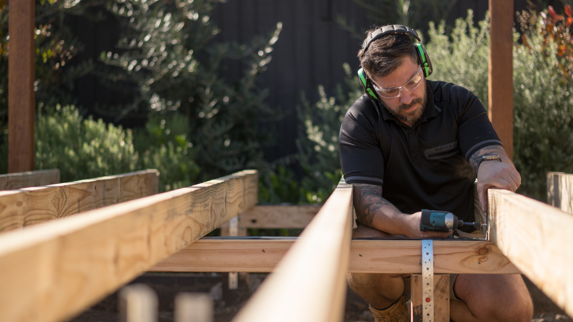 Using a nail gun to attach nails to metal support brackets
