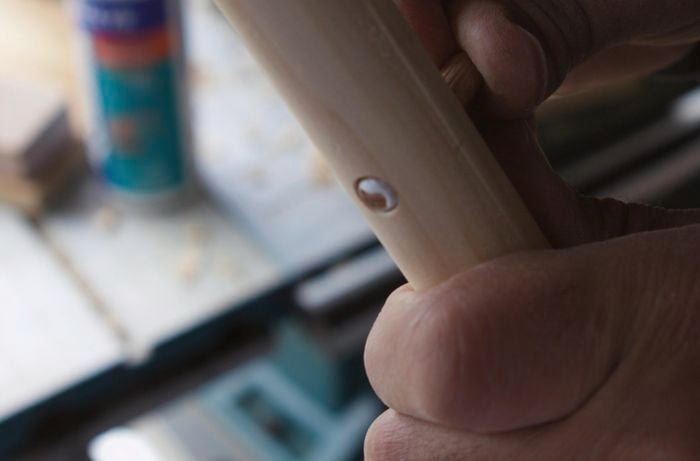 A dowel connector being joined with a piece of timber