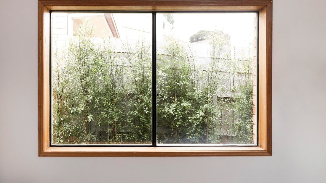 A window with a single mullion, in a small interior setting