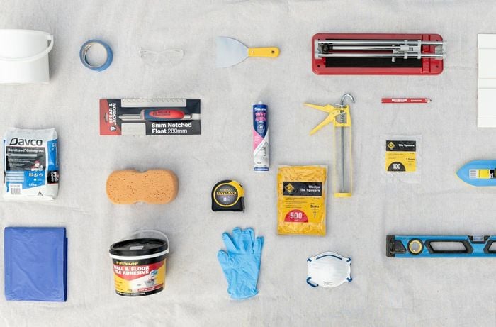 White bench with assorted tools and material 