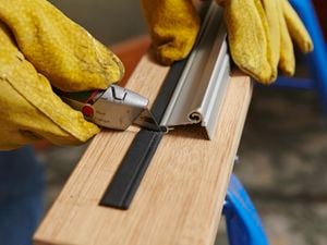 Bunnings person fixing door seal