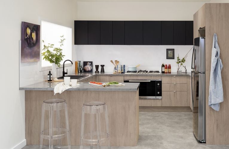 Kitchen with C-shaped benchtop, oven and stool