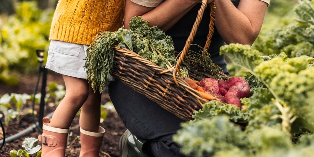 Woman and child in vegetable garden 