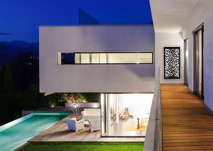 Exterior of home with timber decking and decorative screen