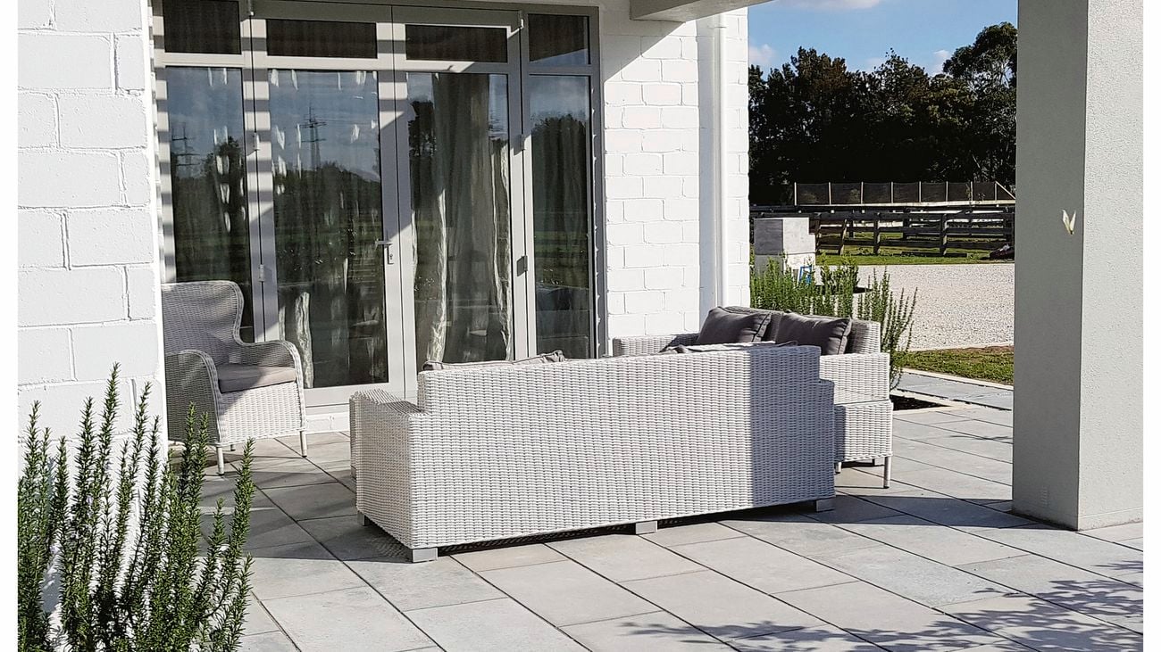 Paved outdoor area with outdoor furniture.
