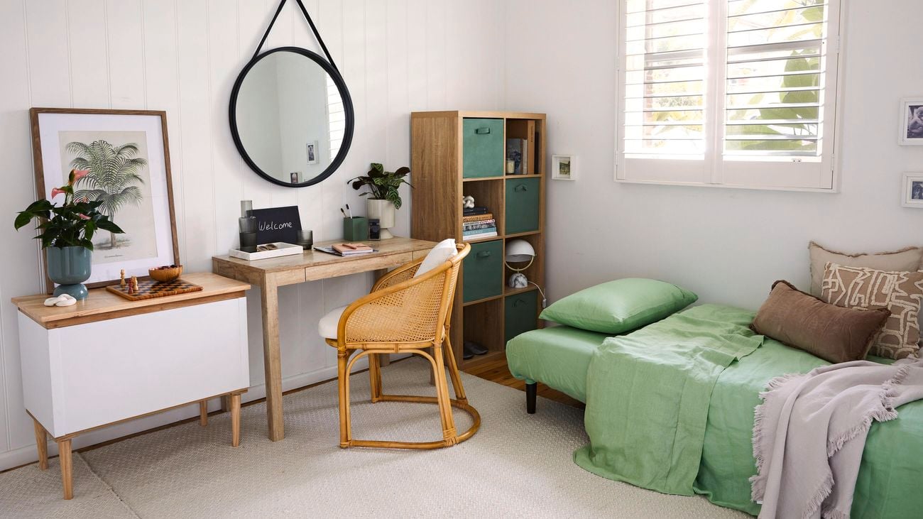  Bedroom featuring a single sofa bed with green and timber decor accessories