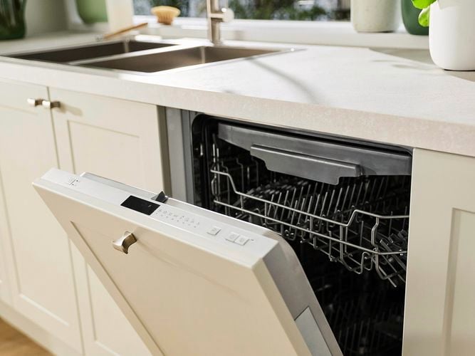 Kitchen with a door open of a Dishwasher in it.