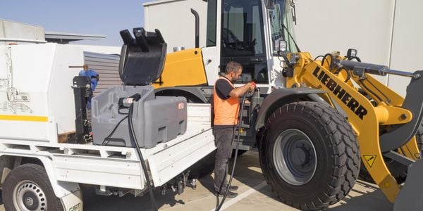 Man filling up his tractor with diesel.