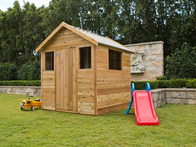 Timber shed with gable roof, door and windows in a garden setting