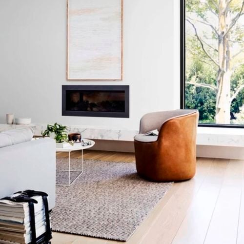 Bright living room with wall fireplace.