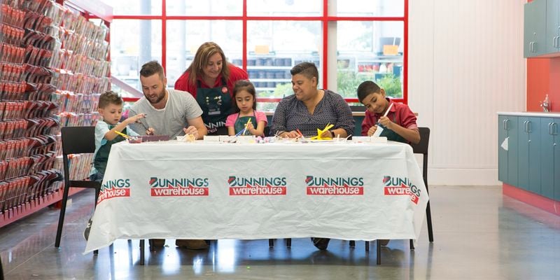 Bunnings team member and families at a kids workshop in-store.