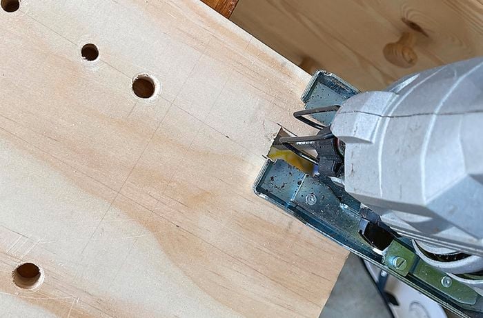 A piece of wood with a drill cutting into it