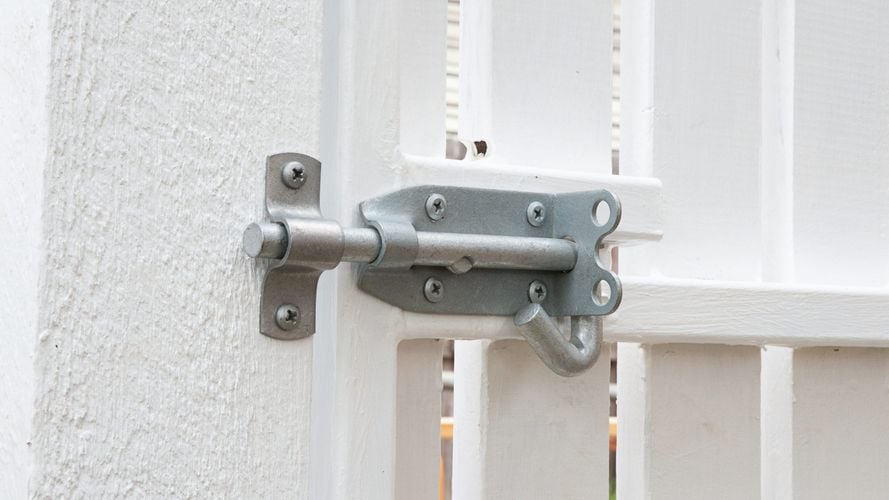 A Pinnacle galvanised padbolt on a white gate.