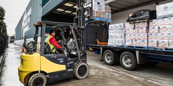 Forklift removing pallets from truck