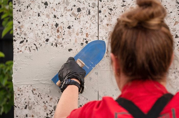 Applying grout using a grout float.