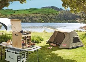 Tent and camping equipment by the river.