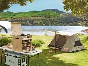 Tent and camping equipment by the river.