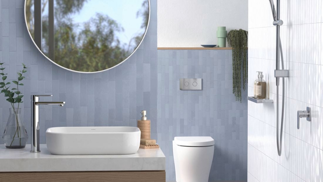 Blue tiled bathroom with silver tapware.